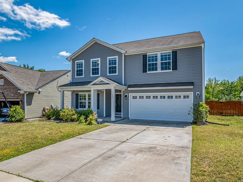 Two-story home with a long concrete driveway