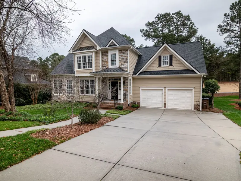 Home with a wide concrete driveway and two-car garage
