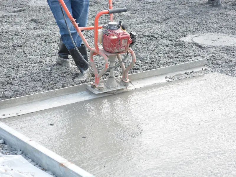 Power trowel finishing a freshly poured concrete slab