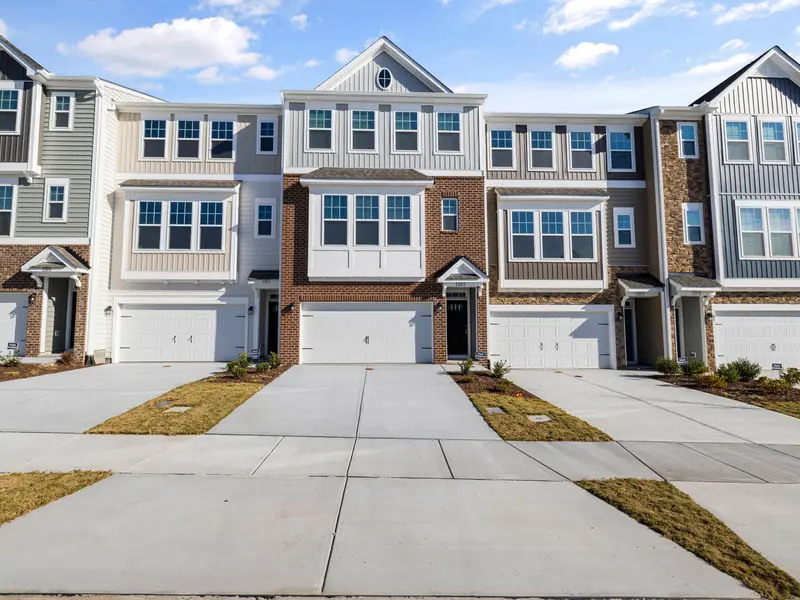 Row of homes with concrete driveways and walkways